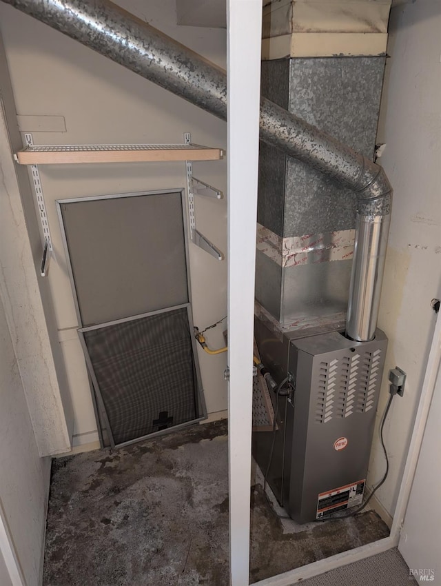 utility room featuring heating unit