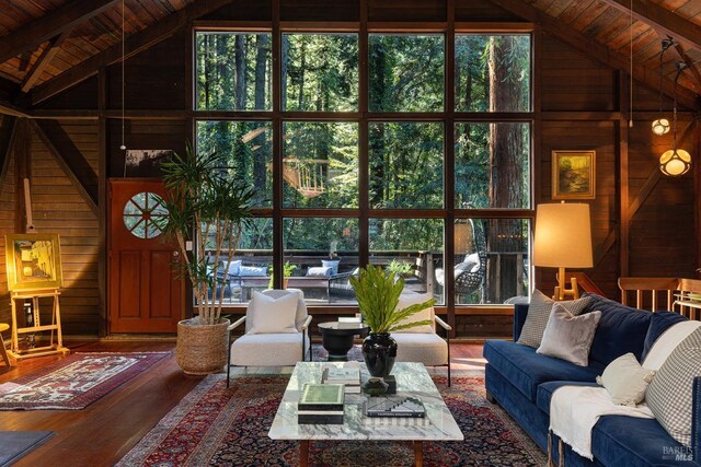 living room featuring wood walls, wood ceiling, and high vaulted ceiling