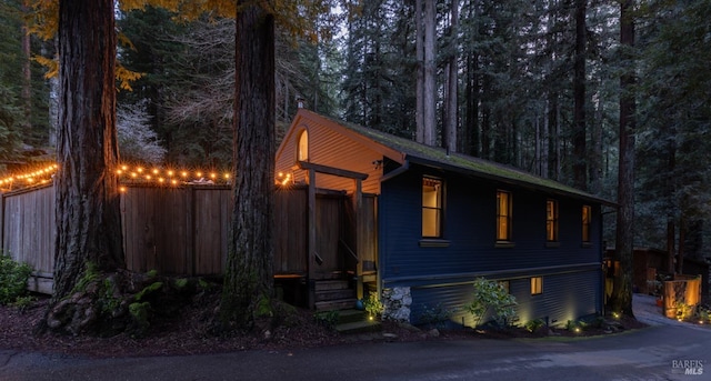 chalet / cabin featuring a wooded view