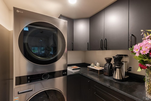 laundry area with stacked washer and clothes dryer