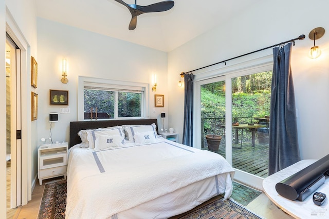 bedroom featuring a ceiling fan, multiple windows, and light wood finished floors