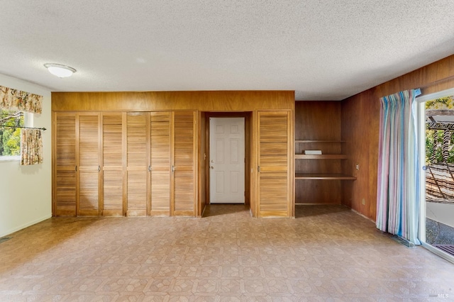 1740 Sereno Dr, Vallejo, CA 94589 - interior space featuring access to outside, baseboards, a textured ceiling, wood walls, and visible vents