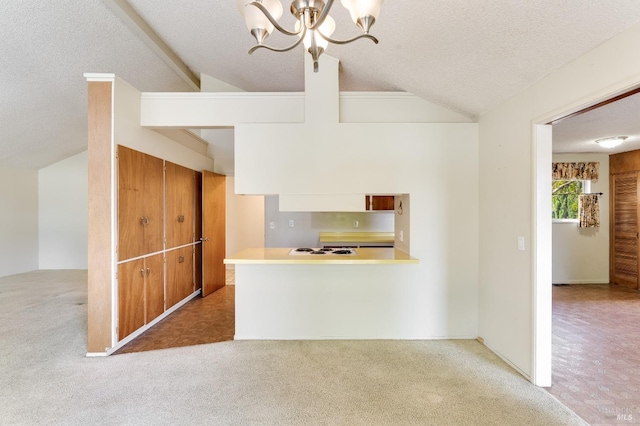 1740 Sereno Dr, Vallejo, CA 94589 - kitchen with a notable chandelier, vaulted ceiling, light countertops, a textured ceiling, and carpet floors