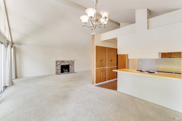 1740 Sereno Dr, Vallejo, CA 94589 - unfurnished living room featuring an inviting chandelier, lofted ceiling with beams, a fireplace, a textured ceiling, and carpet