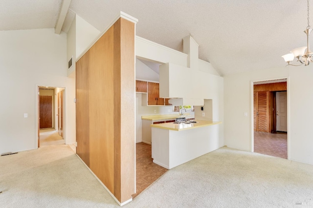 1740 Sereno Dr, Vallejo, CA 94589 - kitchen with light carpet, high vaulted ceiling, light countertops, and an inviting chandelier