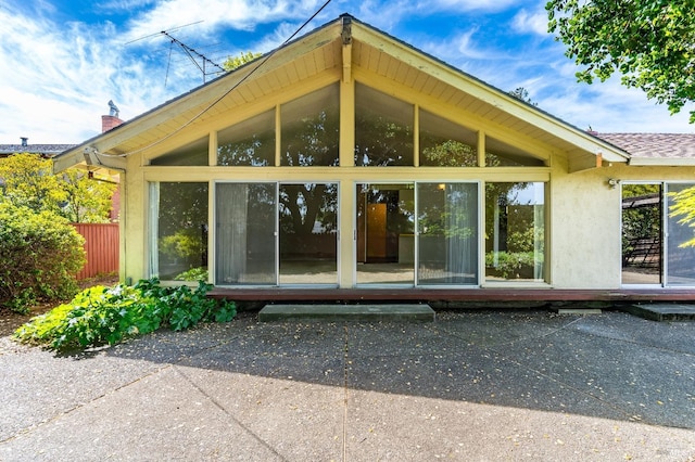 1740 Sereno Dr, Vallejo, CA 94589 - rear view of property with a chimney, fence, a sunroom, and stucco siding