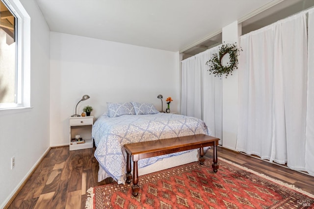 bedroom featuring wood finished floors and baseboards
