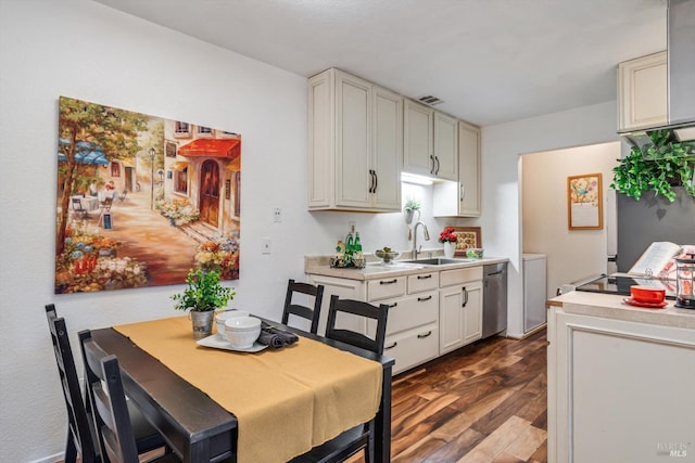 kitchen featuring light countertops, dishwasher, dark wood-type flooring, and a sink