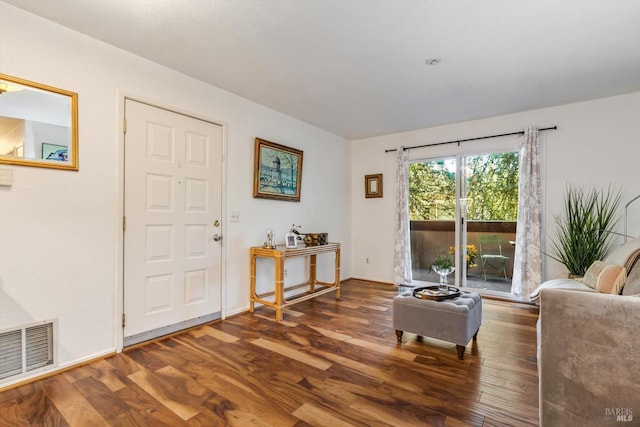 living room with visible vents and wood finished floors
