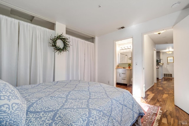 bedroom with visible vents and wood finished floors
