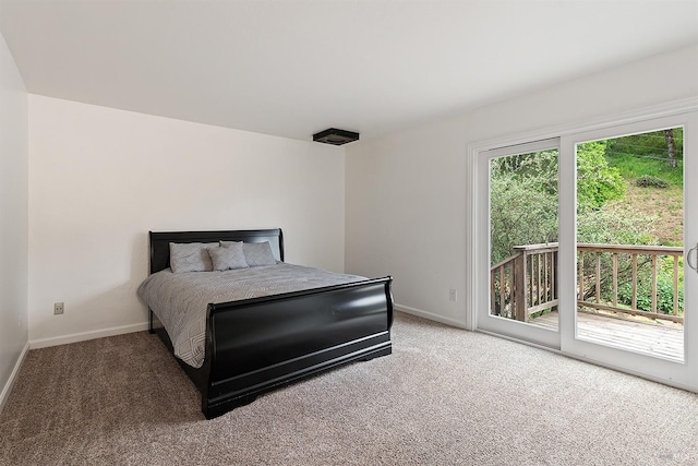 carpeted bedroom featuring access to outside and baseboards