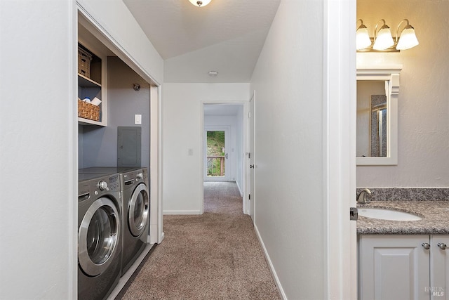clothes washing area with baseboards, a sink, laundry area, carpet floors, and washing machine and clothes dryer