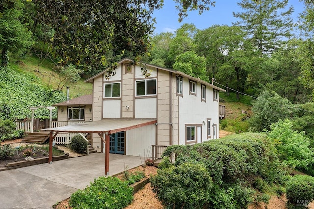 rear view of property featuring a deck