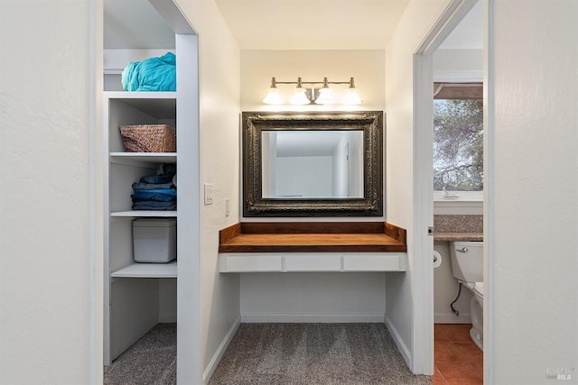 bathroom with toilet and baseboards