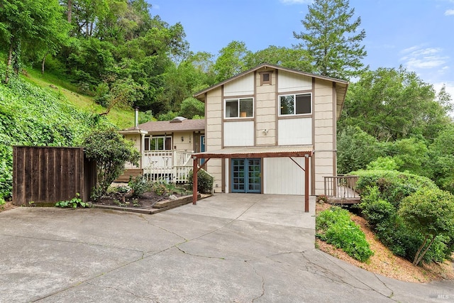 tri-level home featuring french doors and driveway