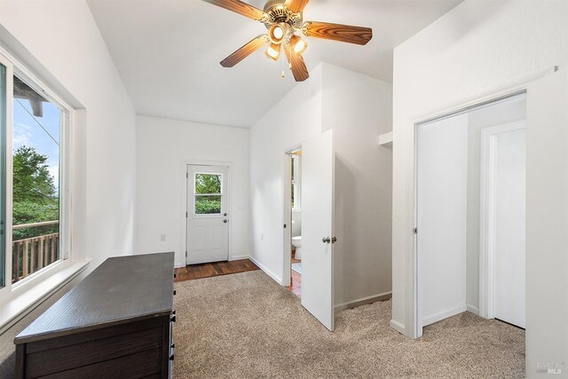 interior space with carpet flooring, baseboards, and ceiling fan