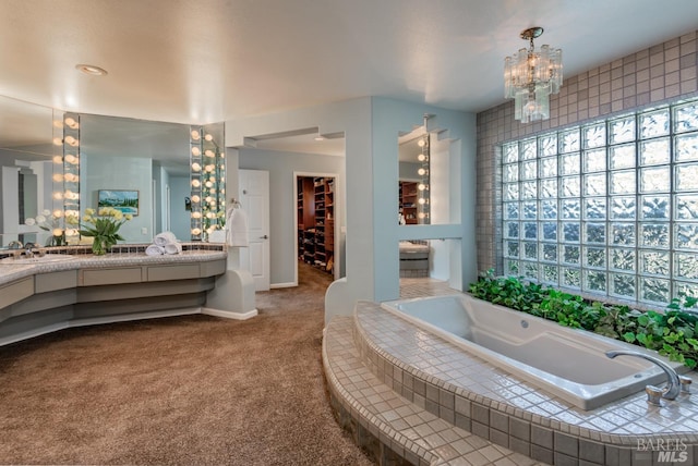 full bathroom with a chandelier, vanity, baseboards, and a garden tub