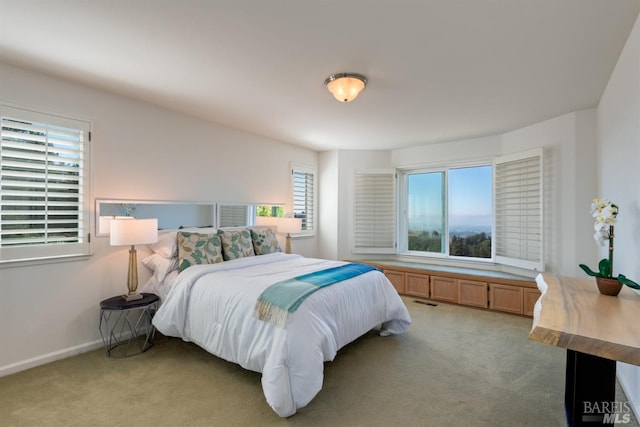 bedroom featuring light carpet, visible vents, and baseboards