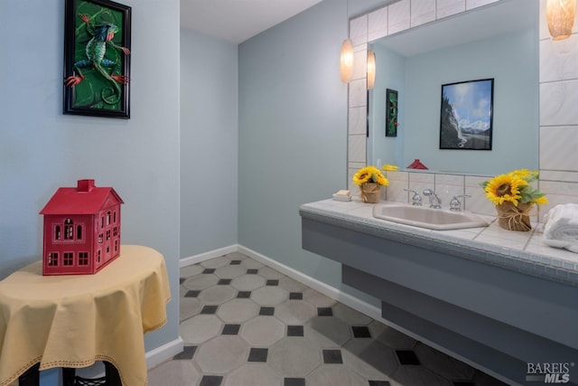 bathroom with baseboards and a sink