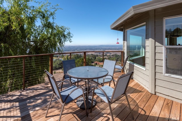 wooden terrace with outdoor dining area