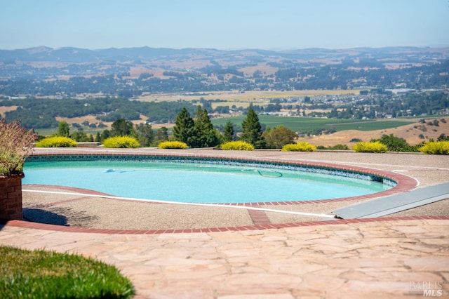 view of pool with a mountain view