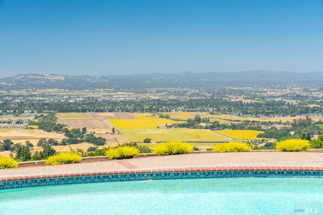 view of swimming pool with a mountain view