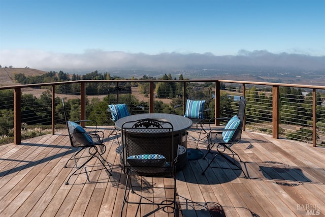 wooden terrace with outdoor dining area