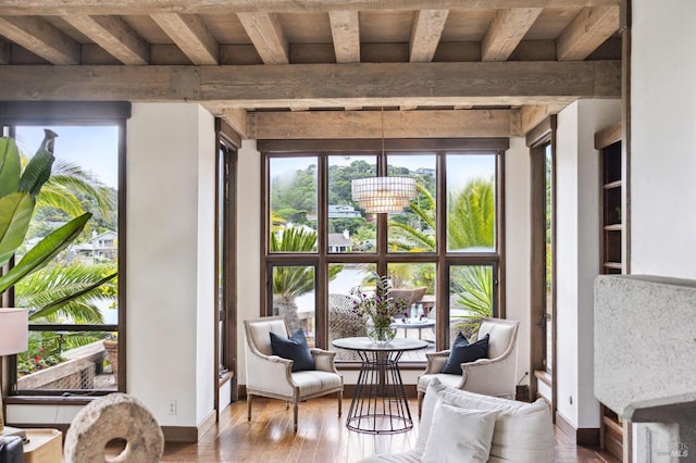 sunroom featuring beamed ceiling