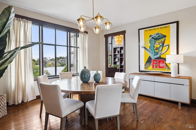 dining room featuring an inviting chandelier and dark wood-style floors