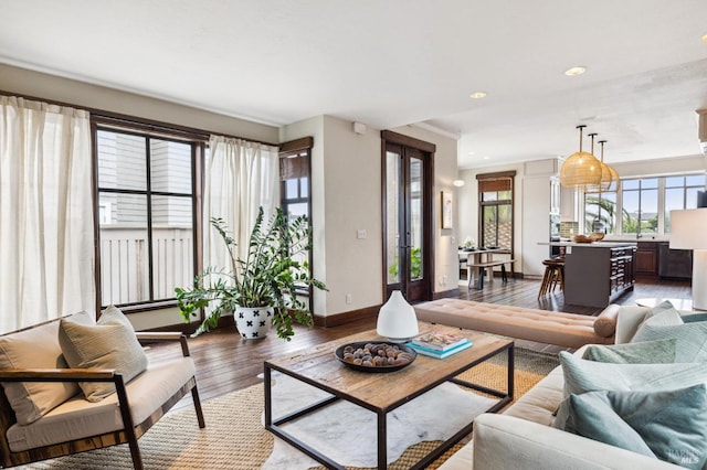 living room featuring light wood finished floors, baseboards, and recessed lighting