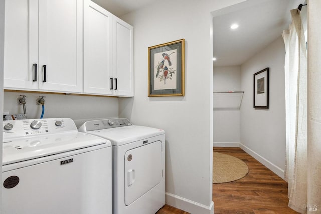 laundry area with baseboards, recessed lighting, wood finished floors, cabinet space, and washing machine and dryer