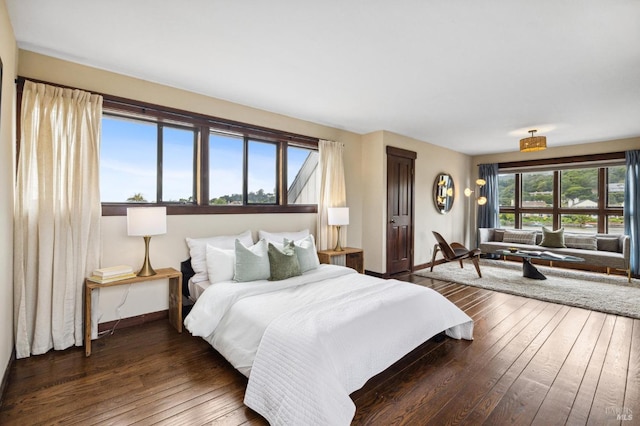 bedroom with wood-type flooring and baseboards