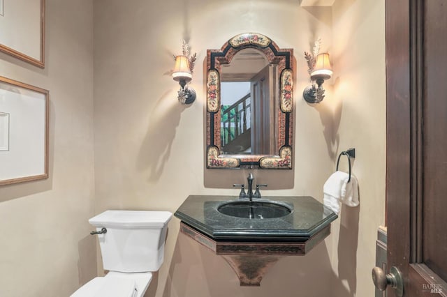 half bathroom with toilet and a sink