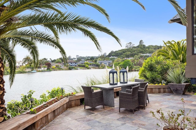 view of patio / terrace with outdoor dining area and a water view
