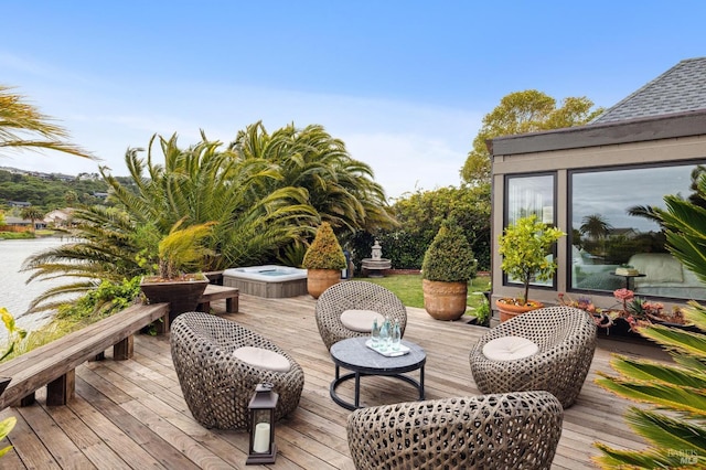 deck with an outdoor hot tub
