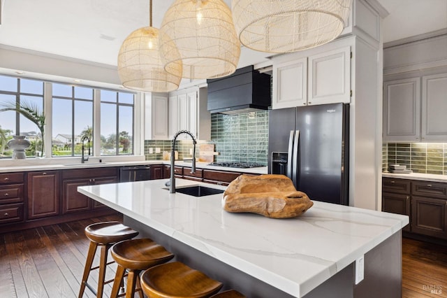kitchen featuring custom range hood, fridge with ice dispenser, dark wood-style flooring, and a sink