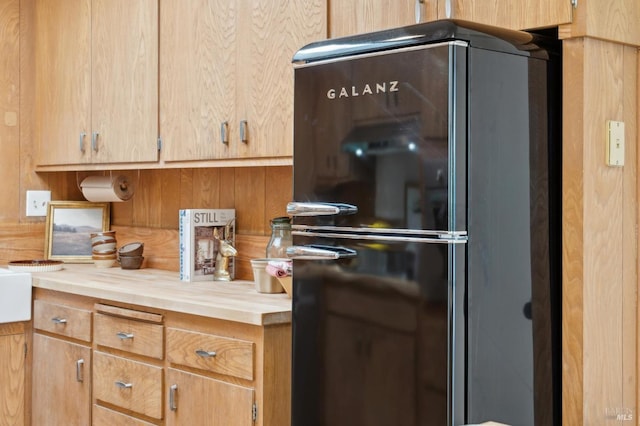 kitchen with light countertops and freestanding refrigerator