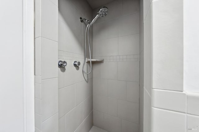 bathroom with tiled shower