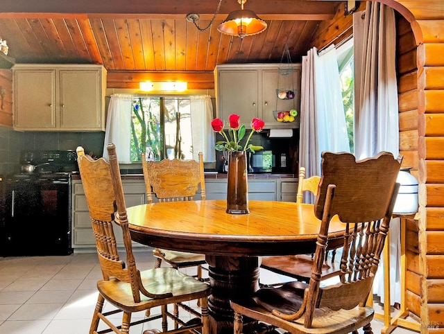 dining area featuring light tile patterned floors and wood ceiling