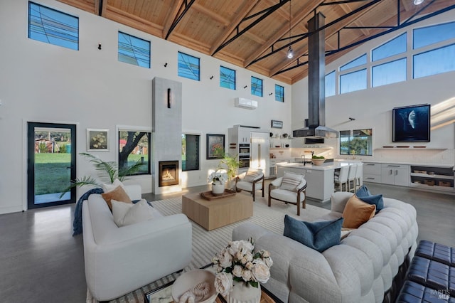 living area featuring high vaulted ceiling, wood ceiling, beam ceiling, and a lit fireplace