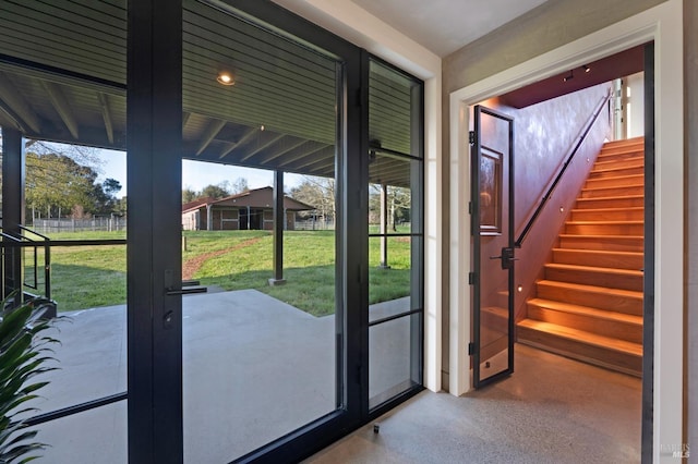 entryway featuring a wealth of natural light and stairway