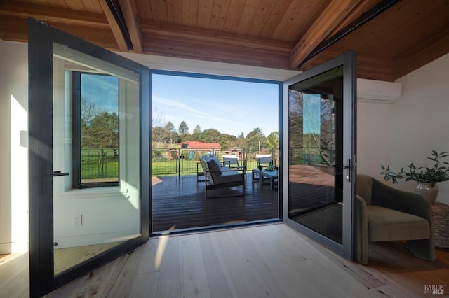doorway featuring a wall unit AC, wooden ceiling, beam ceiling, and wood finished floors