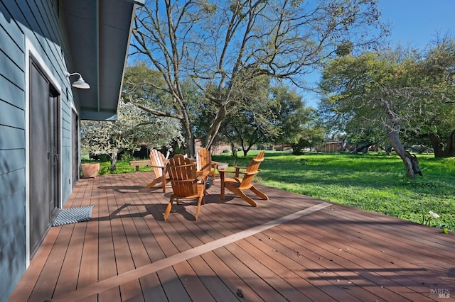 wooden terrace featuring a yard