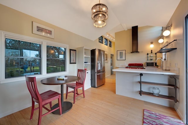 kitchen with wall chimney exhaust hood, light wood-style flooring, a peninsula, open shelves, and appliances with stainless steel finishes