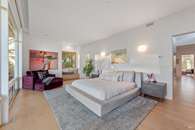 bedroom featuring light wood finished floors and visible vents