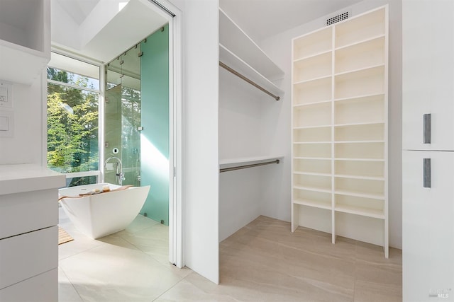 walk in closet with visible vents and light tile patterned flooring