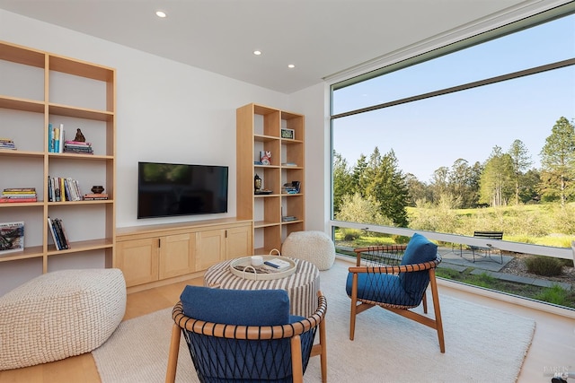 interior space with floor to ceiling windows, recessed lighting, and light wood-style floors