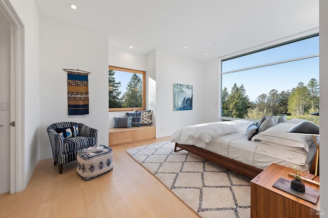 bedroom with wood finished floors and recessed lighting
