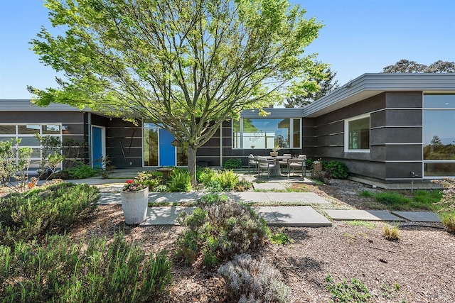 view of yard featuring a sunroom and a patio area