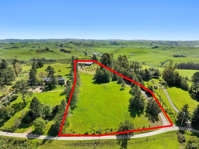 drone / aerial view featuring a mountain view and a rural view